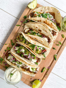 braised beef tacos on a board