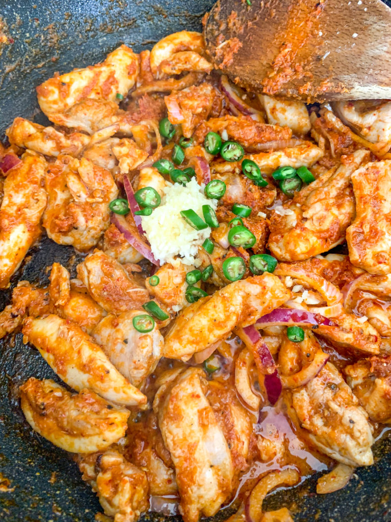 thai red curry process shot chicken frying with paste and spices