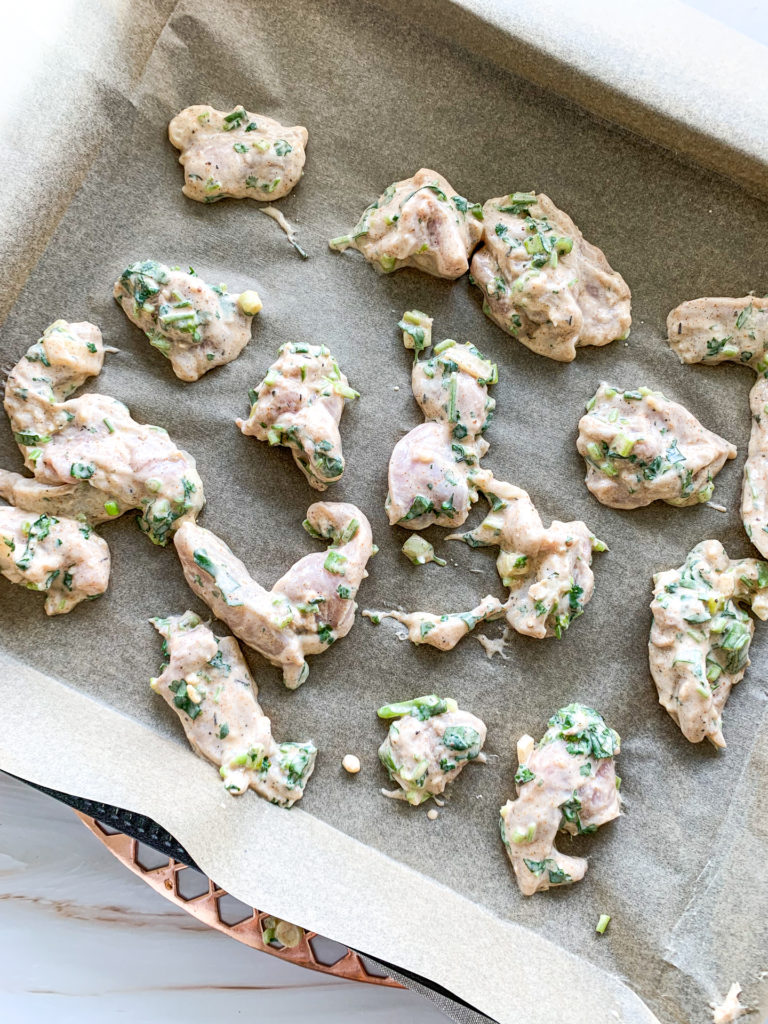 marinated chicken on baking tray