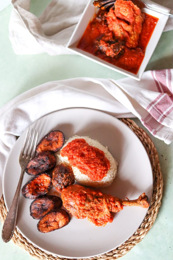 nigerian red stew with chicken beef and plantain on white rice