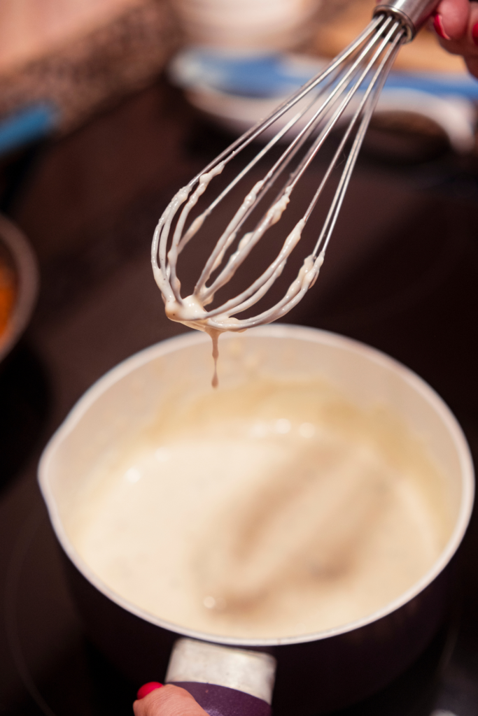 whisking bechamel sauce